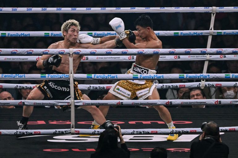 Naoya Inoue (L) fights Junto Nakatani during their super bantamweight championship boxing contest at Tokyo Dome in Tokyo on May 2, 2026. (Photo by Yuichi YAMAZAKI / AFP)