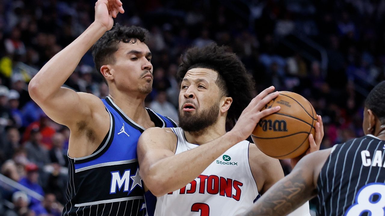 Detroit Pistons guard Cade Cunningham (2) goes to the basket between Orlando Magic forward Tristan da Silva (23) and forward Jamal Cain (8) during the first half in Game 5 of a first-round NBA basketball playoffs series Wednesday, April 29, 2026, in Detroit. (AP Photo/Duane Burleson)