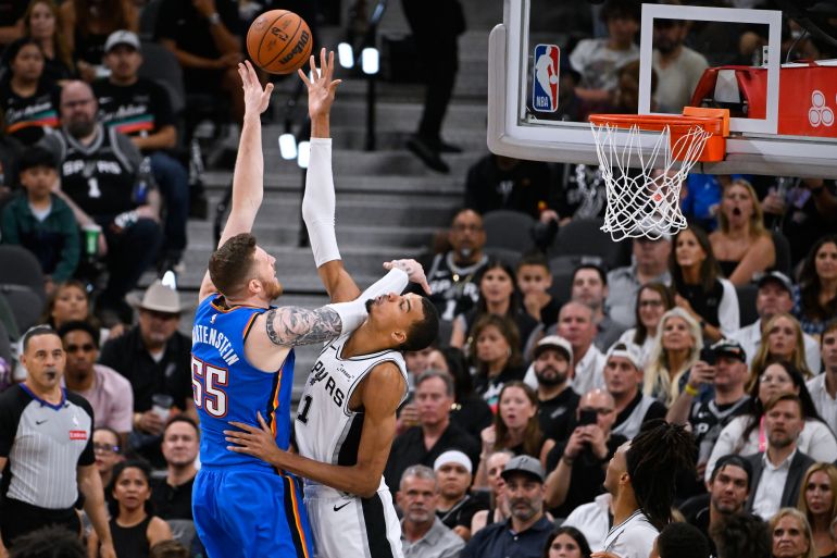 San Antonio Spurs forward Victor Wembanyama, right, blocks a shot by Oklahoma City Thunder center Isaiah Hartenstein during the second half of Game 4 in the Western Conference finals NBA basketball playoffs series in San Antonio, Sunday, May 24, 2026. (AP Photo/Darren Abate)