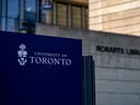 Close up of University of Toronto sign with Robarts Library in background. 
