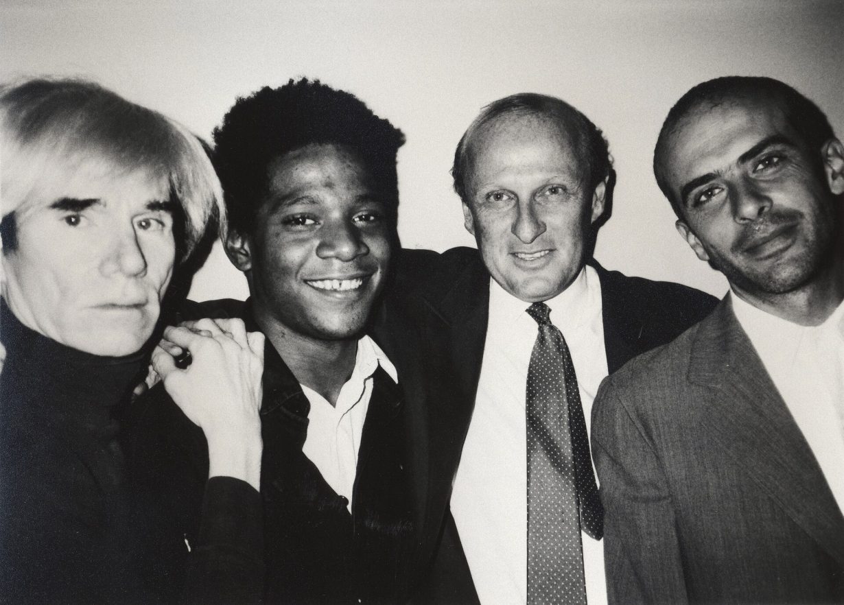 Photo of Andy Warhol, Jean-Michel Basquiat, Bruno Bischofberger and Fransesco Clemente, in New York, 1984. 
