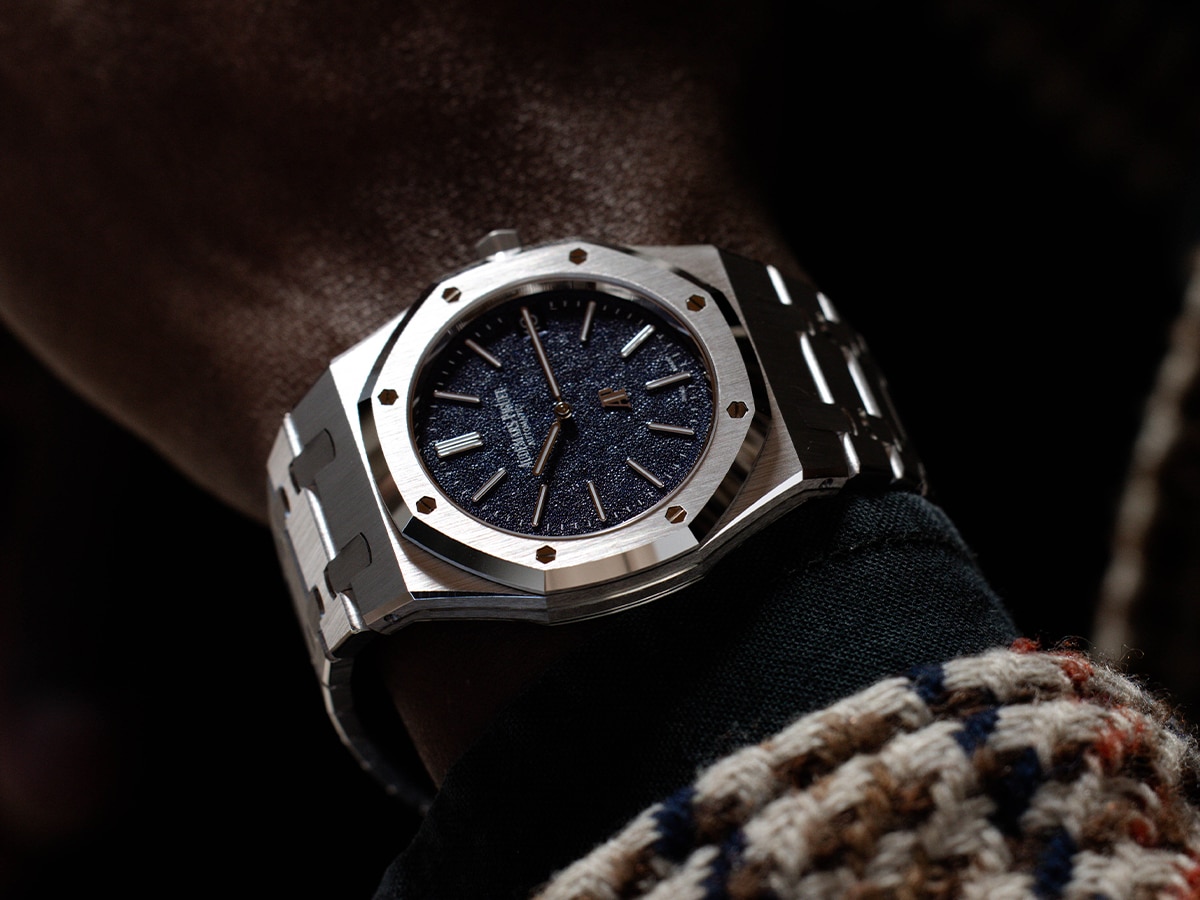 Audemars Piguet Royal Oak Jumbo Extra Thin watch with blue textured dial on wrist, stainless steel bracelet.