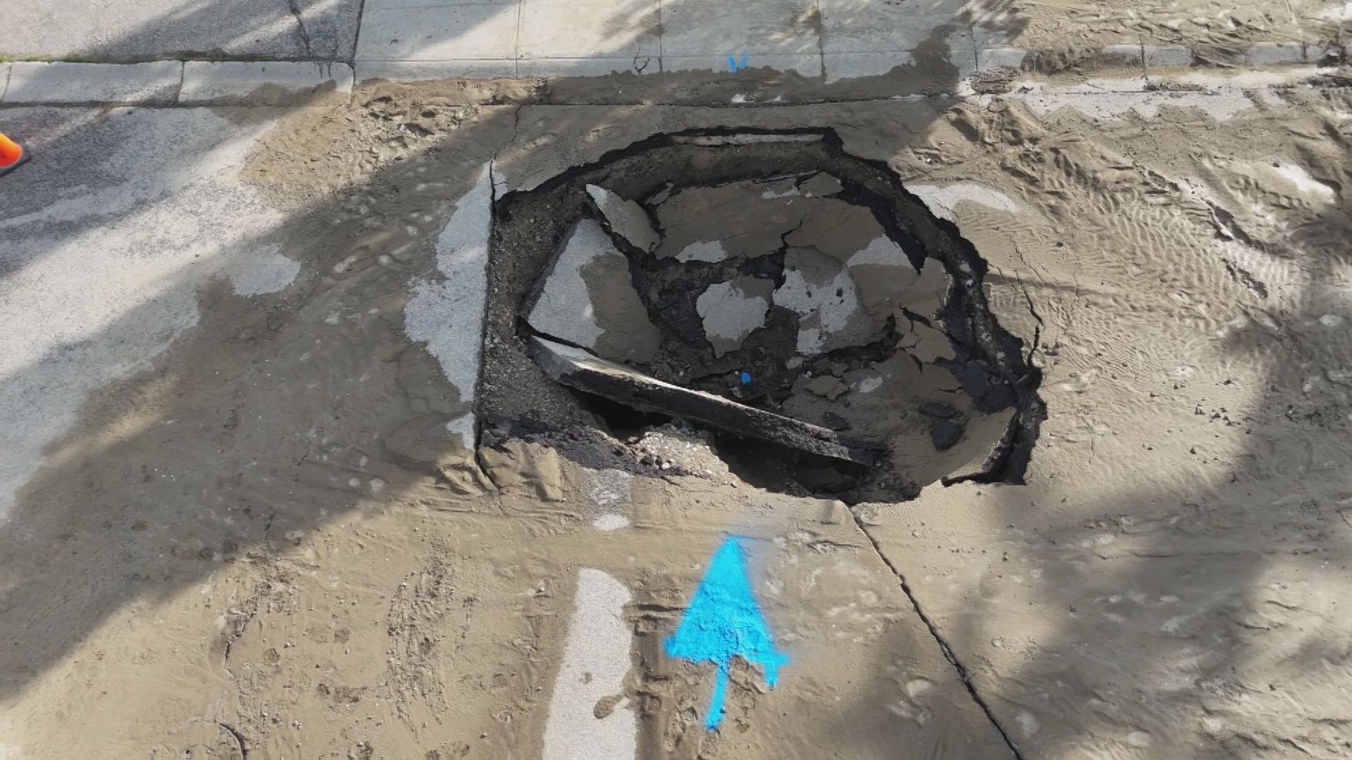 A large opening in the road, the result of a water main break in the Coach Hill area in northwest Calgary on Wednesday, May 27, 2026