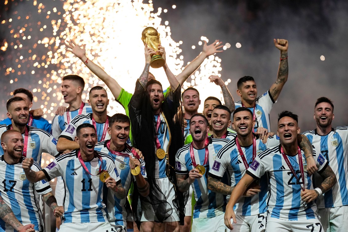 Lionel Messi holds the World Cup trophy after Argentina's victory at the 2022 FIFA World Cup