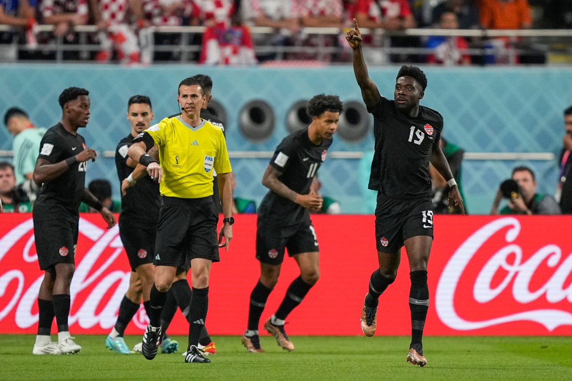 Alphonso Davies and teammates celebrate a goal