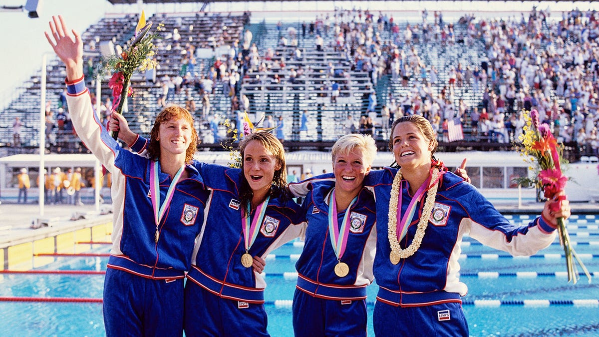 Jenna Johnson, Nancy Hogshead, Carrie Steinseifer and Dara Torres celebrating women's 4x100m freestyle relay win