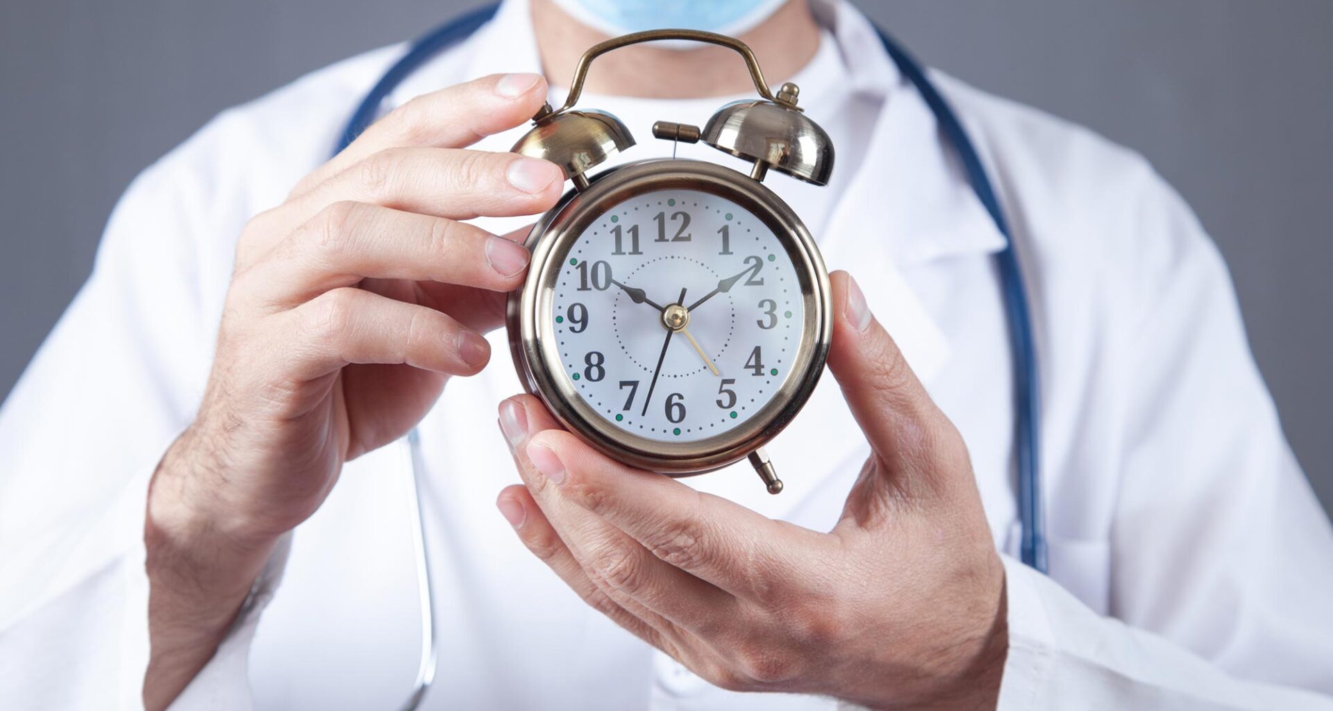 Doctor Holding Alarm Clock Longevity Aging