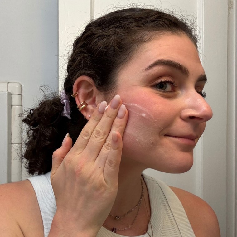A woman using Farmacy’s Green Clean Fragrance-Free Cleansing Balm.