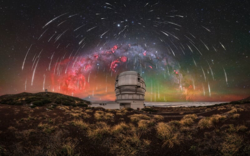 A large observatory dome stands under a vivid night sky filled with colorful stars, meteors, and nebulae. Wispy clouds and bright meteor trails arc above a grassy, rocky landscape.