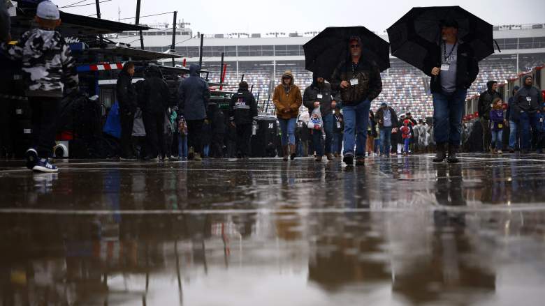 Fans walk through rainy conditions at Charlotte Motor Speedway before the Coca-Cola 600.