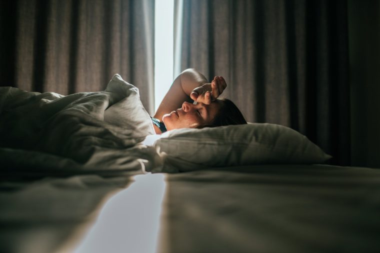 Woman awaking after sleeping well in a nice sleeping room. - stock photo