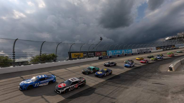Denny Hamlin and Christopher Bell lead cars during a restart at Dover Motor Speedway