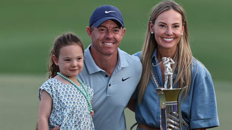 Rory McIlroy poses with wife Erica Stoll and daughter after winning the DP World Tour Race to Dubai title