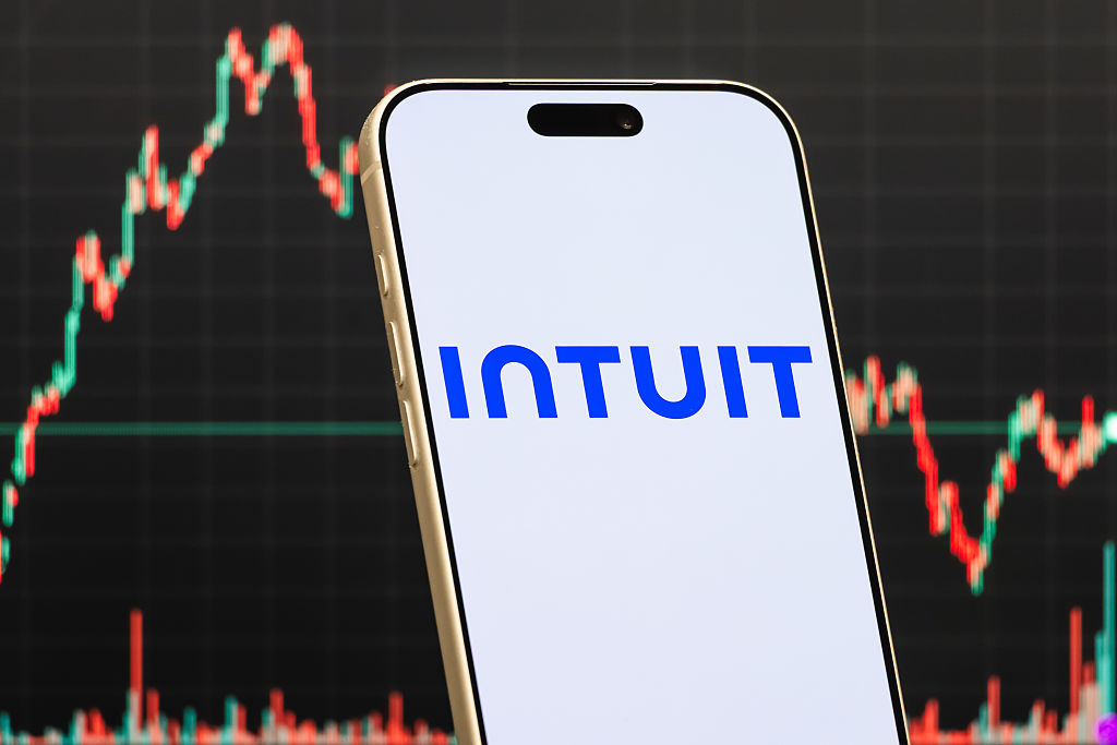 a smartphone displays the logo of Intuit Inc