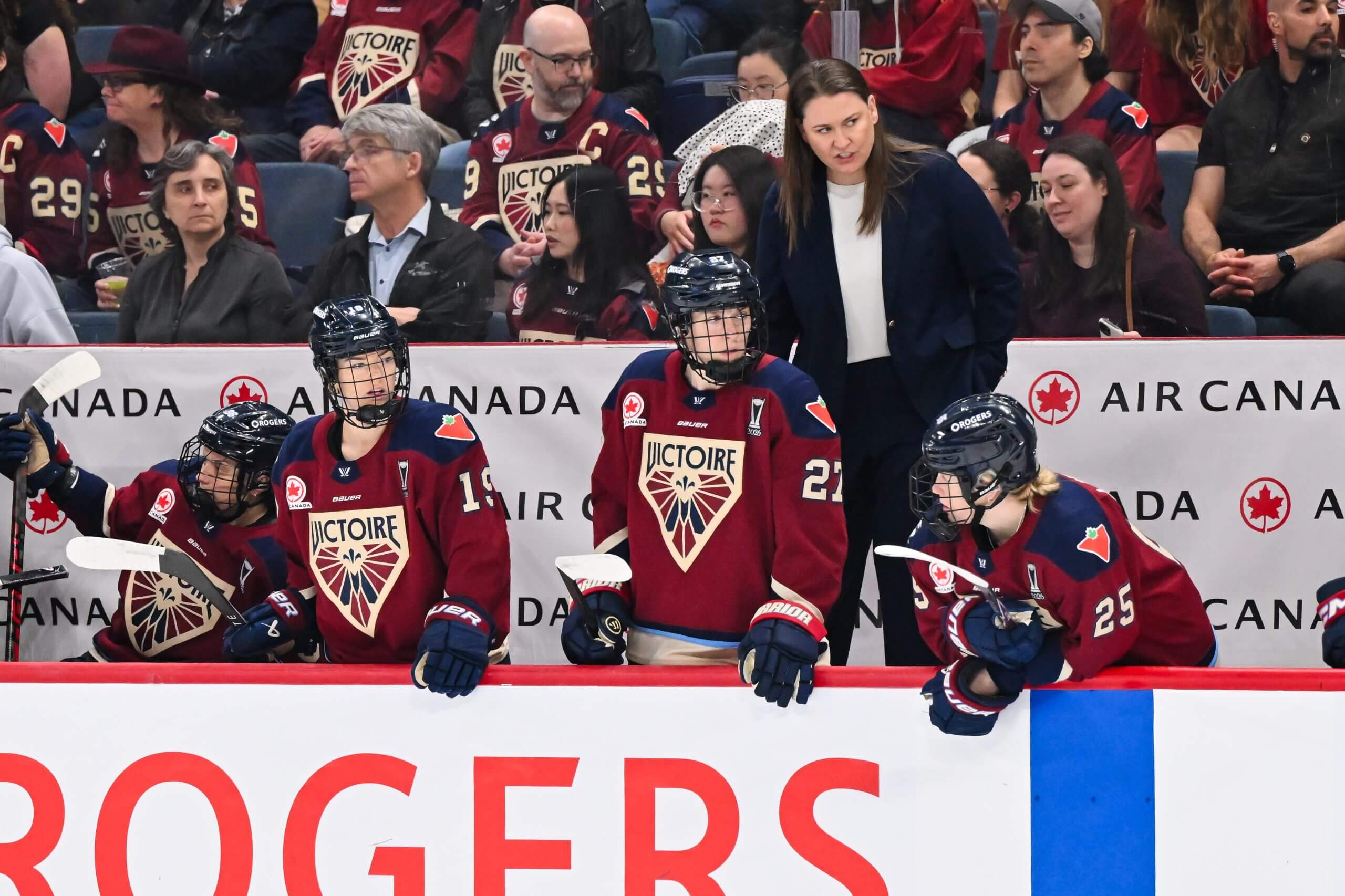 Coach Kori Cheverie stands behind the Montreal bench.