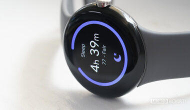 A Google Pixel Watch rests on its side displaying a user's sleep score.