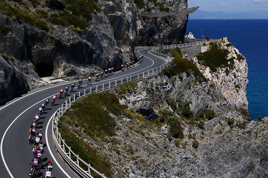 The pack rides at Noli Cape during the 12th stage of the Giro d'Italia 2026 - Tour of Italy cycling race between Imperia and Novi Ligure, Italy, on May 21, 2026. (Photo by Luca Bettini / AFP)