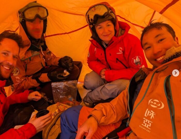 The international four-person team comprising Gilles Denis, Sasha Doyle, Ed Luke, and Wilson Cheung in a tent on the the Greenland Ice Sheet,