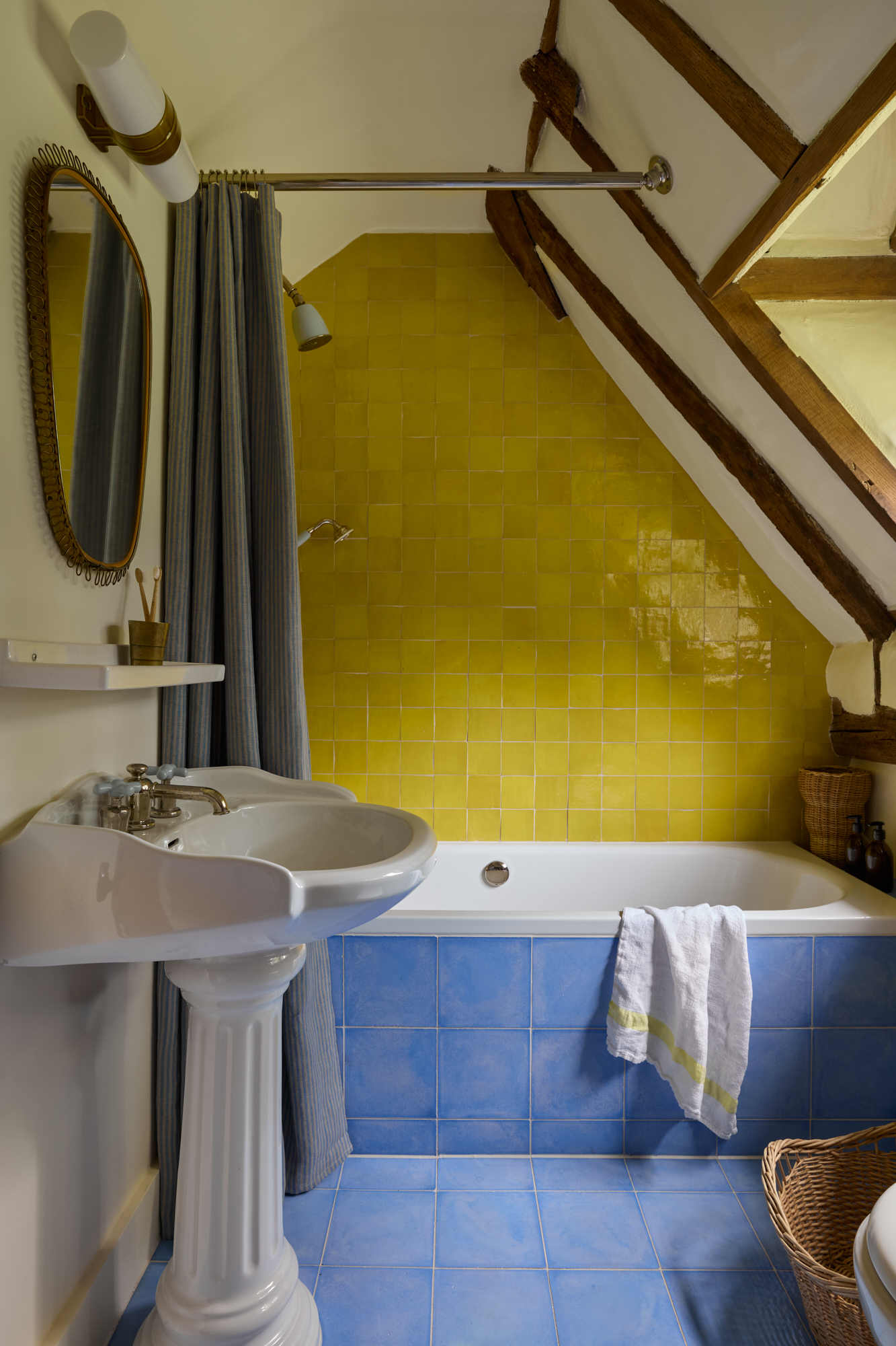 A yellow bathroom with contrasting blue tiling