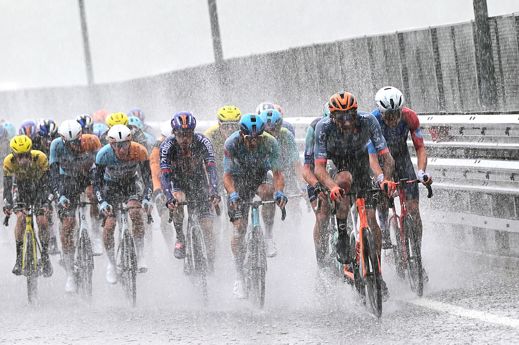 A general view of the peloton competing the peloton competing while it is raining heavily during the 109th Giro d'Italia