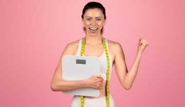 Happy Young Woman Celebrating Weight Loss Success Holding Scale