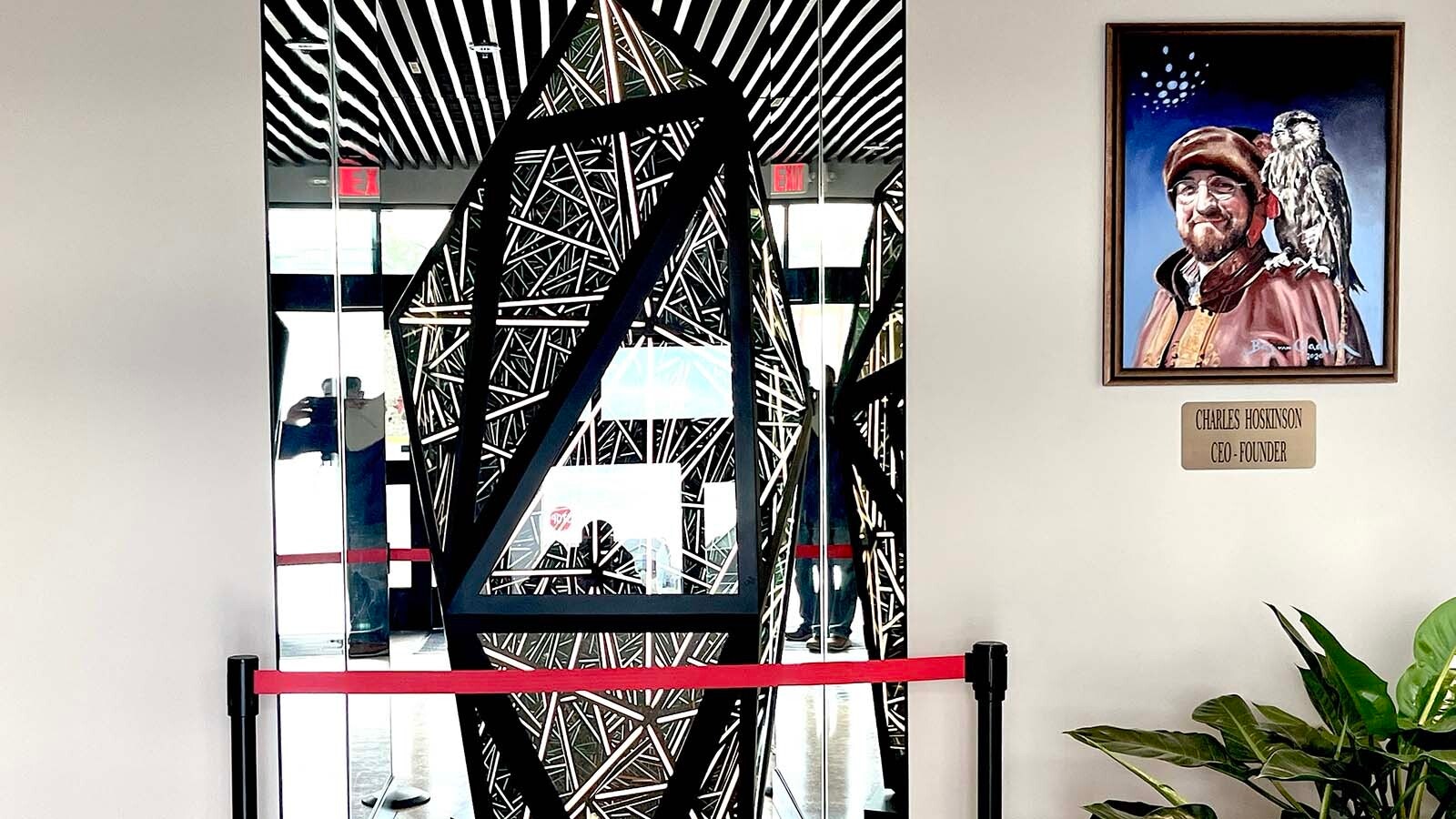 The Infinity Statue in the entryway of Hoskinson Health & Wellness Clinic in Gillette, with a portrait of Charles Hopkinson, who provided the funding to build the clinic.
