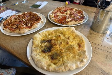 Pizzas and garlic bread from the Wiggles Pizza food stall in The Mad Giant Food Hall