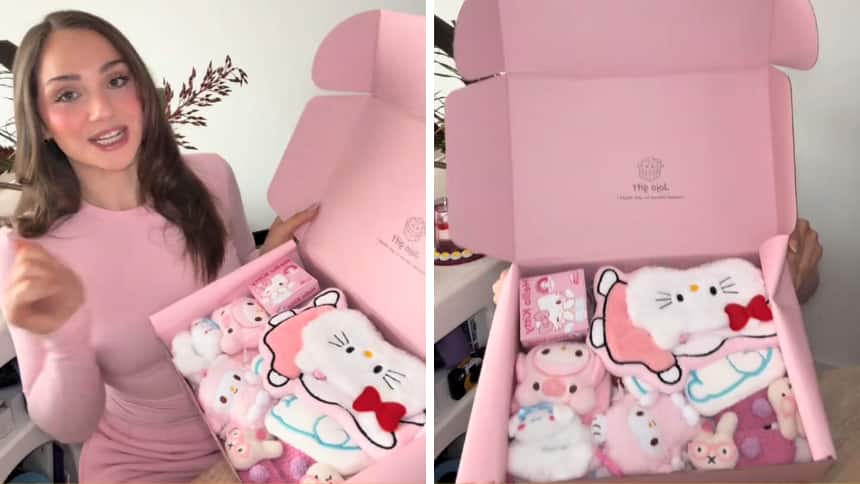 A woman is holding a pink box filled with cute character themed items.