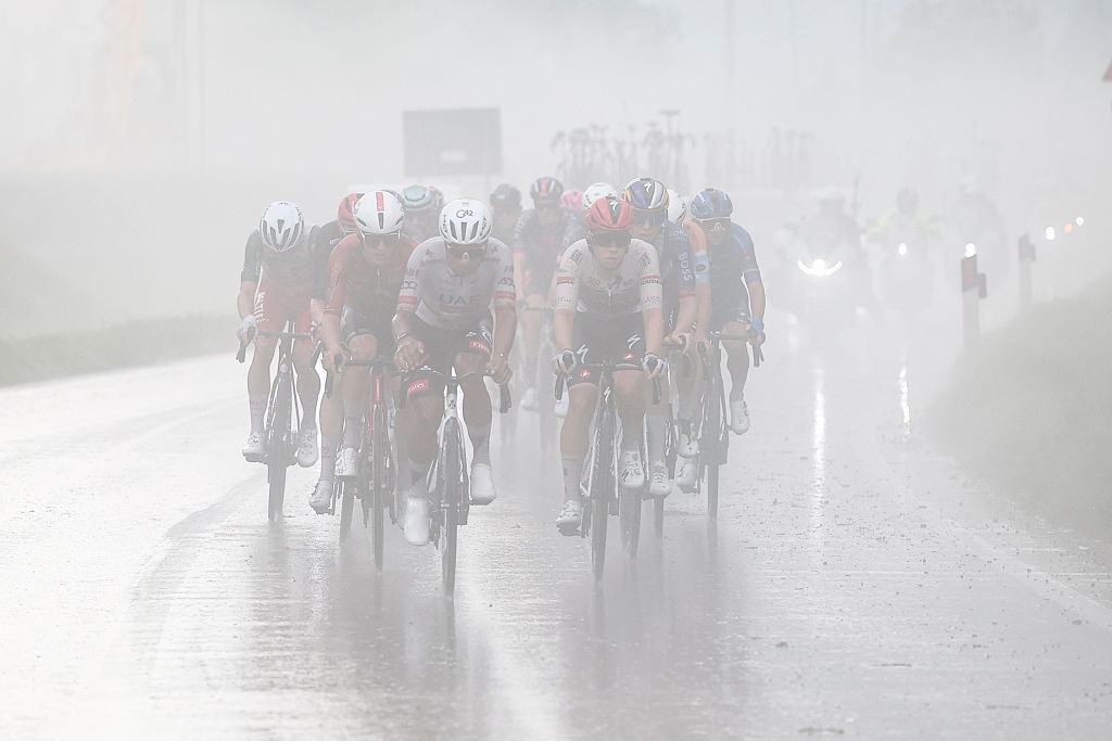 The chasing group rides in heavy rain during the 17th stage of the Giro d'Italia 2026 - Tour of Italy cycling race between Cassano d'Adda and Andalo, Italy, on May 27, 2026. (Photo by Luca Bettini / AFP)