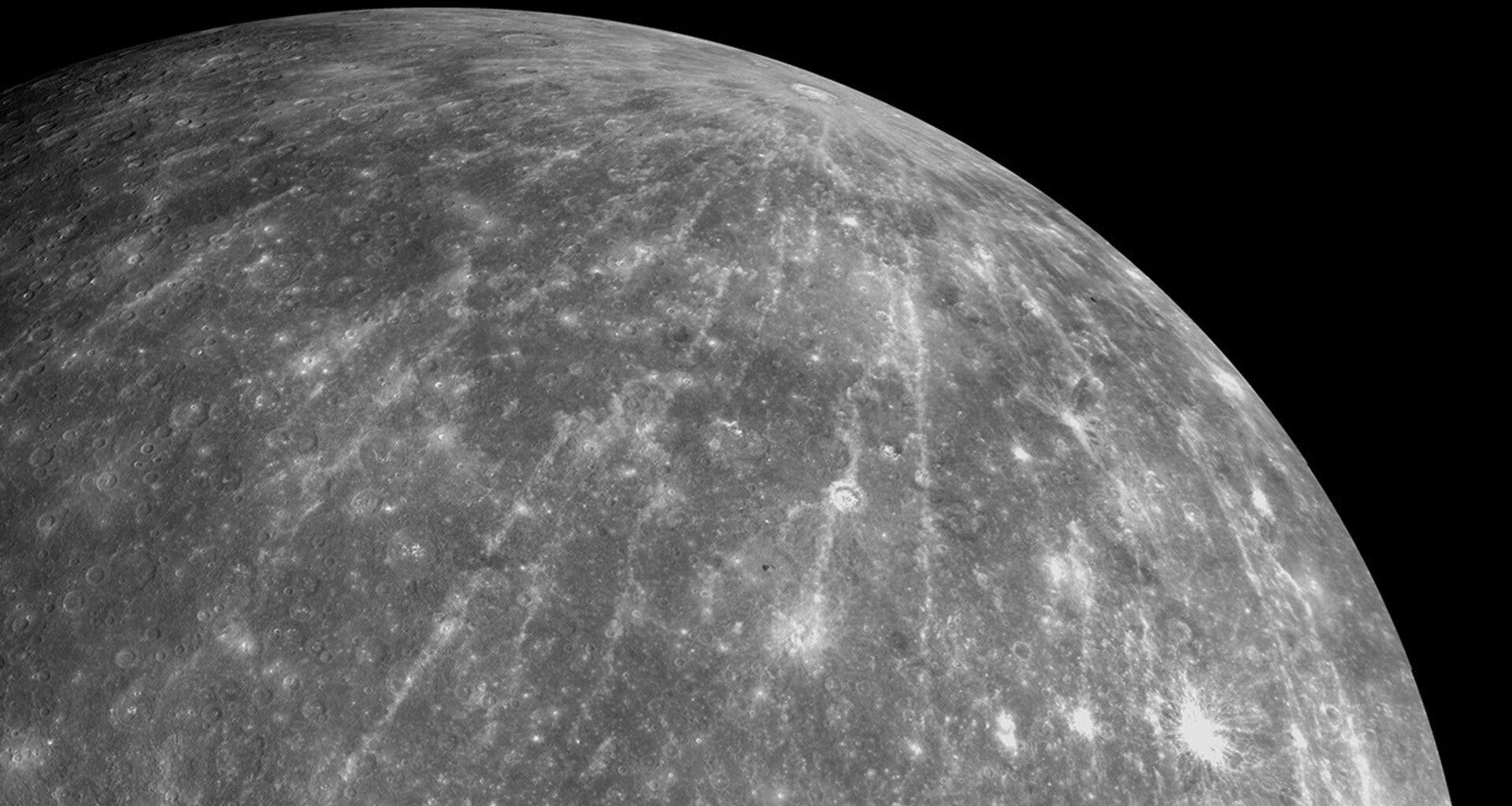 a grey orb streaked with white lines and dotted with white craters
