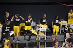 FILE - Los Angeles Sparks players cheer from their socially-distanced seating after a play during the first half of a WNBA basketball game against the Phoenix Mercury, July 25, 2020, in Bradenton, Fla.