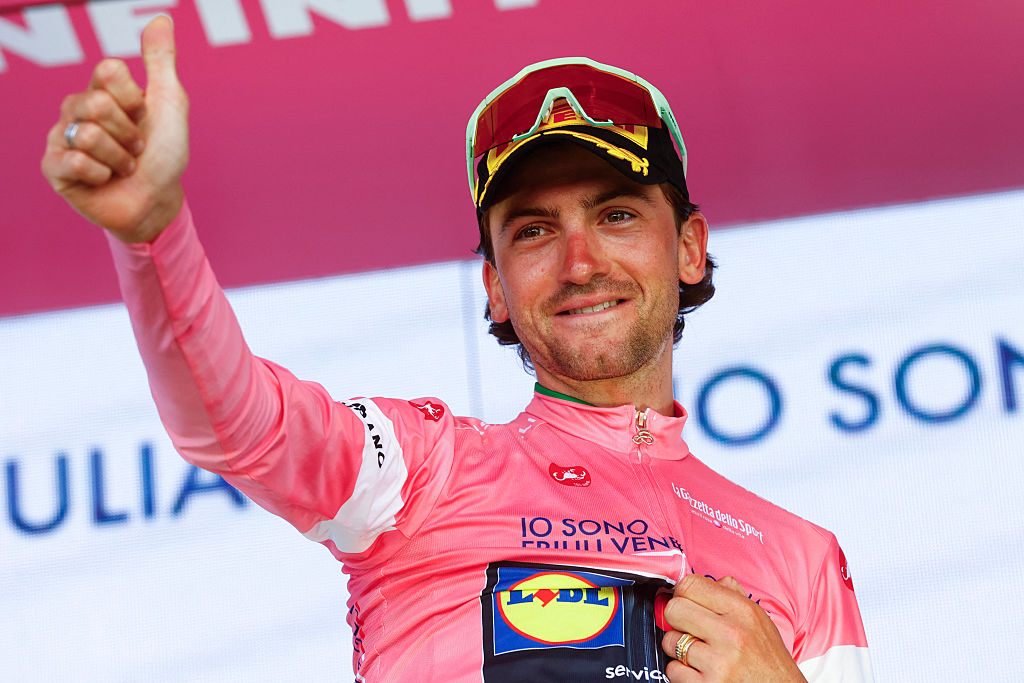 Lidl - Trek Italian rider Giulio Ciccone wearing the overall leader's pink jersey (Maglia Rosa) reacts on the podium after the after winning the 4th stage of the Giro d'Italia 2026 - Tour of Italy cycling race between Catanzaro and Cosenza, Italy, on May 12, 2026. (Photo by Luca Bettini / AFP)