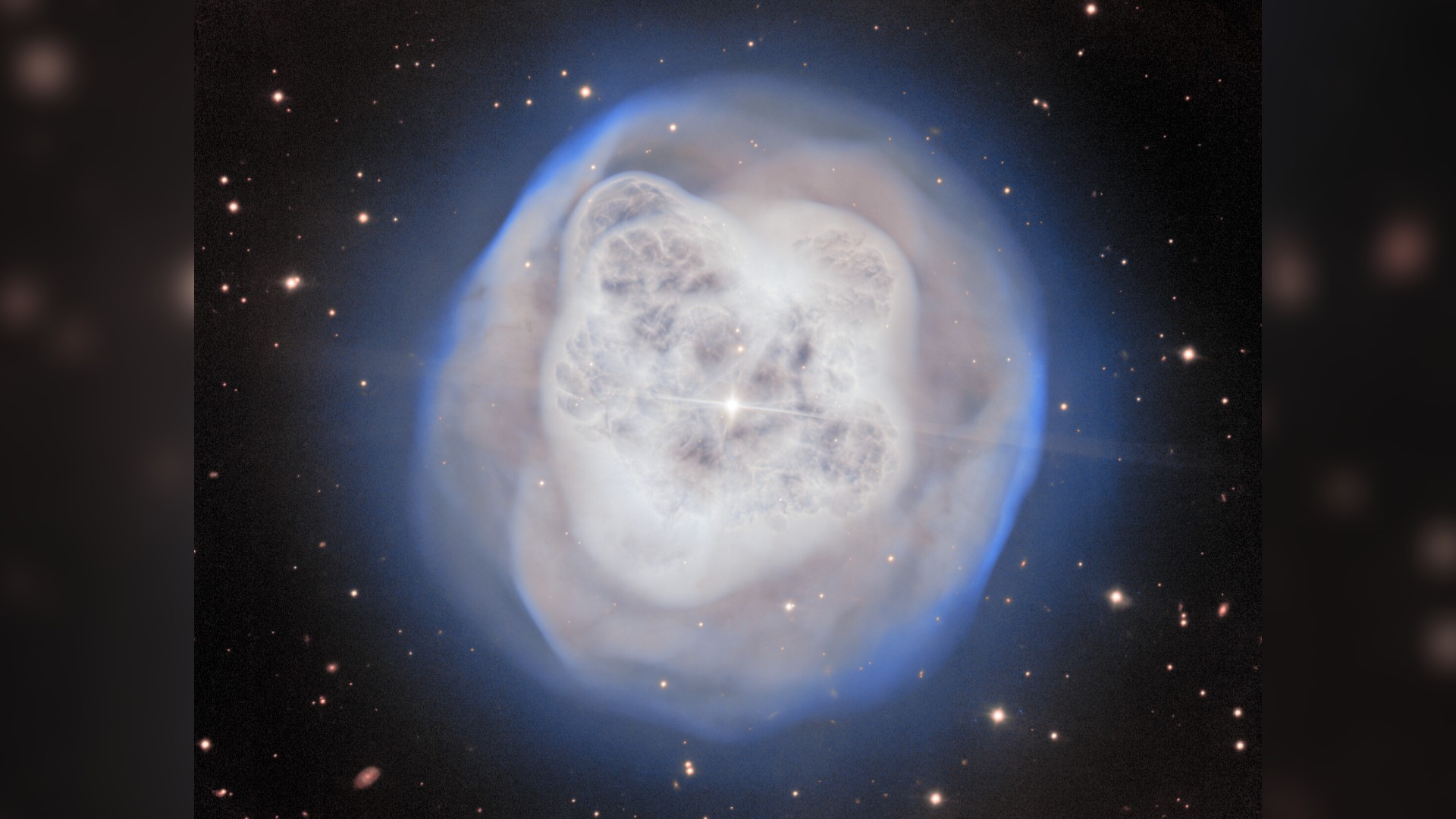 a white orb-shaped cloud of gas on a starry background
