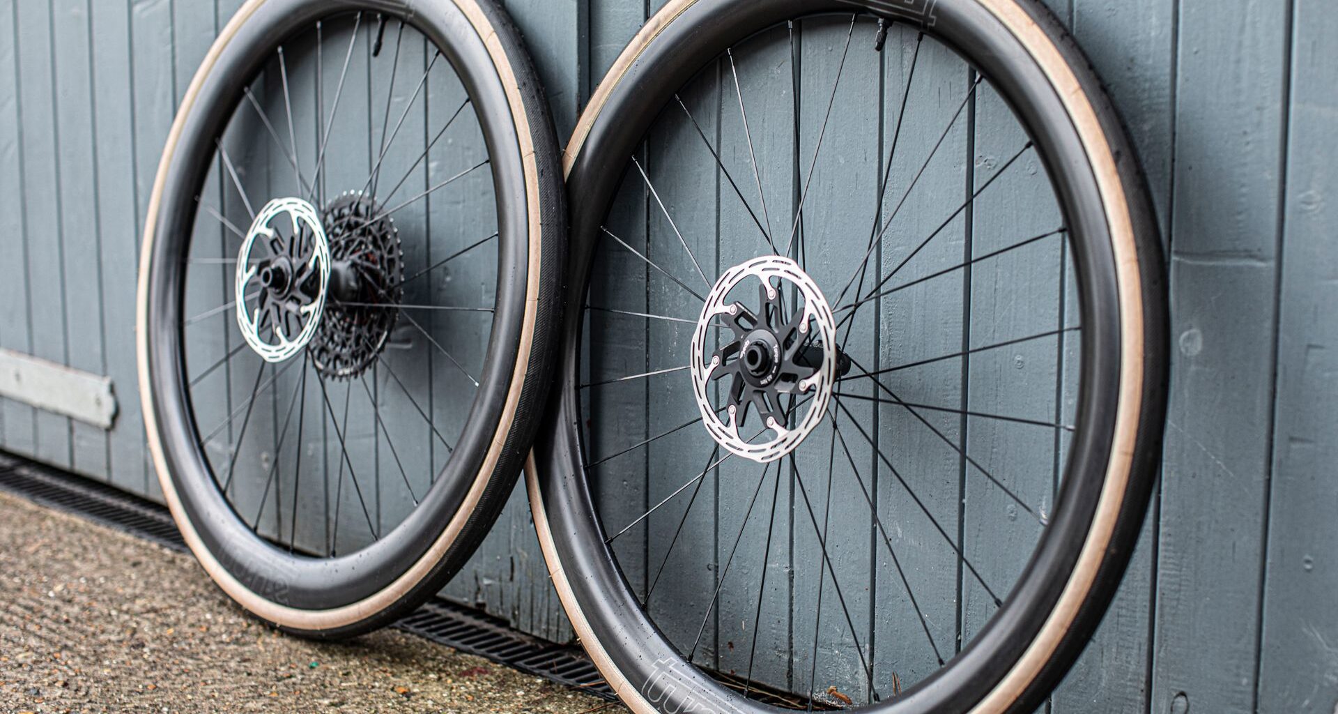 Tune Yokto 4550 wheels leaning against a wooden door painated blue