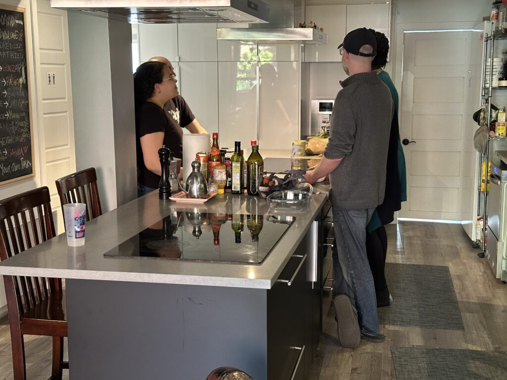 picture of Noco comunity living kitchen with people standing around