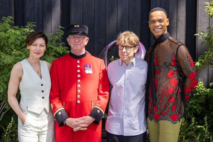 Emma Willis, Josh Widdicombe and Johannes Radebe pose with a Chelsea pensioner, who is in full uniform. He stands between Emma and Josh.