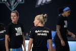 FILE - Chicago Sky guard Courtney Vandersloot, center, and guard Allie Quigley, left, display social awareness messages on their shirts before a WNBA basketball first round playoff game against the Connecticut Sun, Sept. 15, 2020, in Bradenton, Fla.
