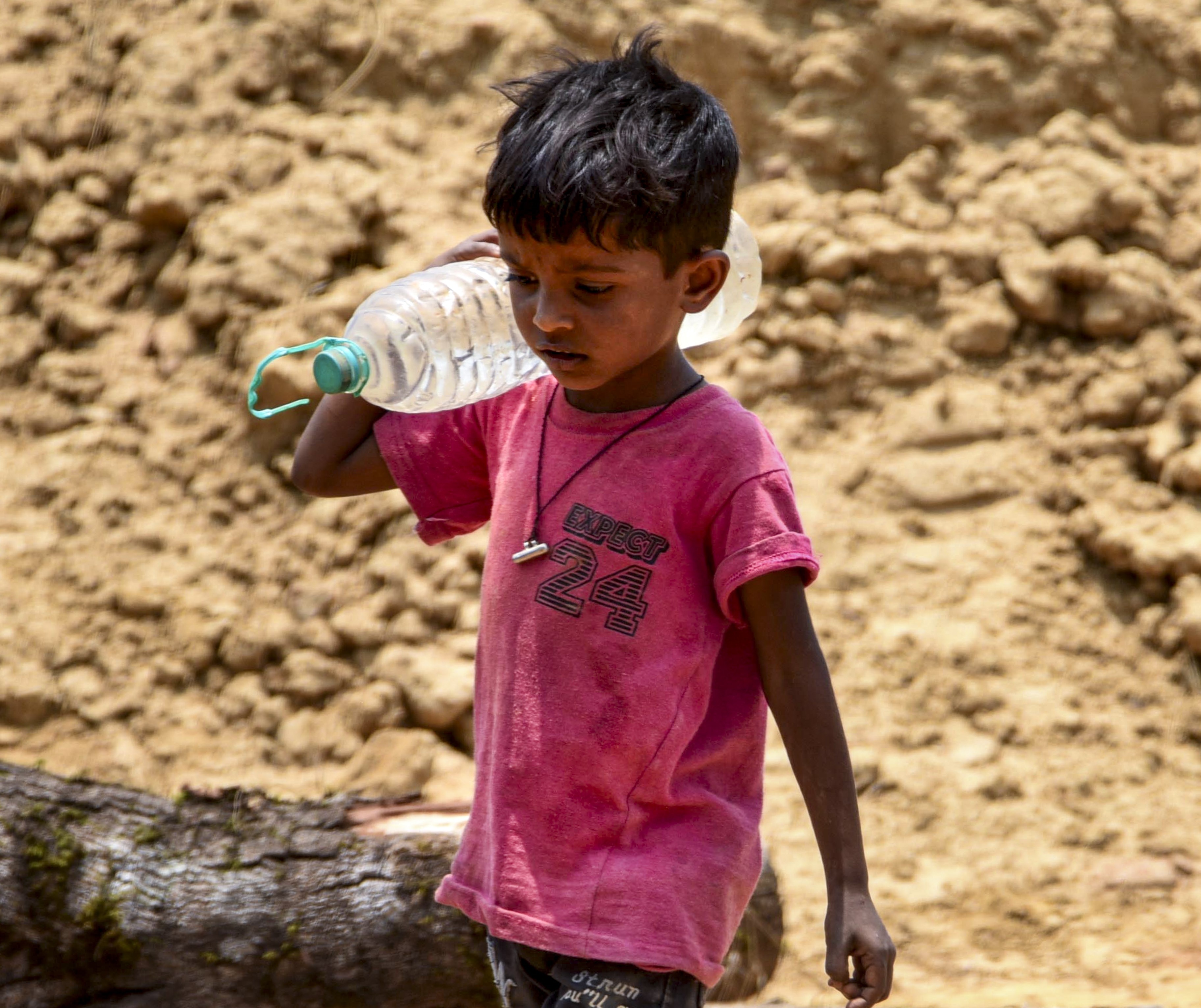 A child carries a bottle filled with tap water on a hot day in Karnataka. (Photo: PTI)