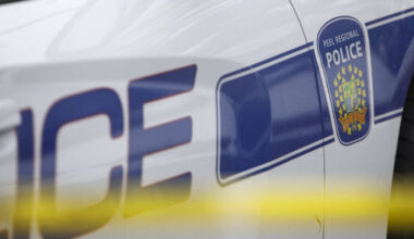A Peel Regional Police cruiser is seen behind yellow caution tape in this undated photo. THE CANADIAN PRESS/Cole Burston