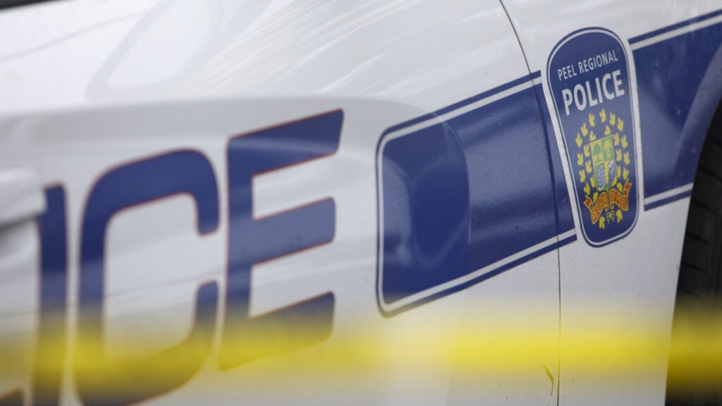 A Peel Regional Police cruiser is seen behind yellow caution tape in this undated photo. THE CANADIAN PRESS/Cole Burston