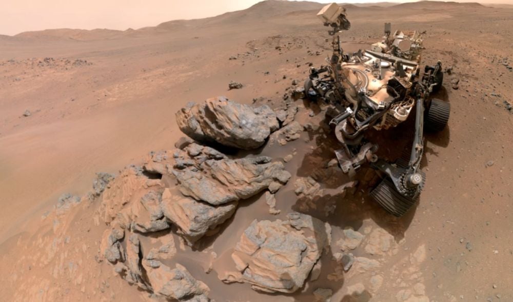NASA's Perseverance rover captured this selfie as it looks down at a rocky outcrop named Arathusa. The image is composed of 61 images taken on March 11th. Arathusa may predate the formation of Jezero Crater, the larger landscape feature that Perseverance is exploring. Image Credit: NASA/JPL-Caltech/MSSS