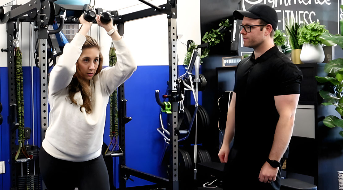 Personal trainer Jeff Payne observing one of his clients on how to workout
