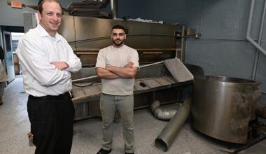 New York Bagels owner Rayyan Kayyali (right) with Rabbi Yonah Gross in front of the oven and kettle, which emerged mostly undamaged from the March 3 explosion.