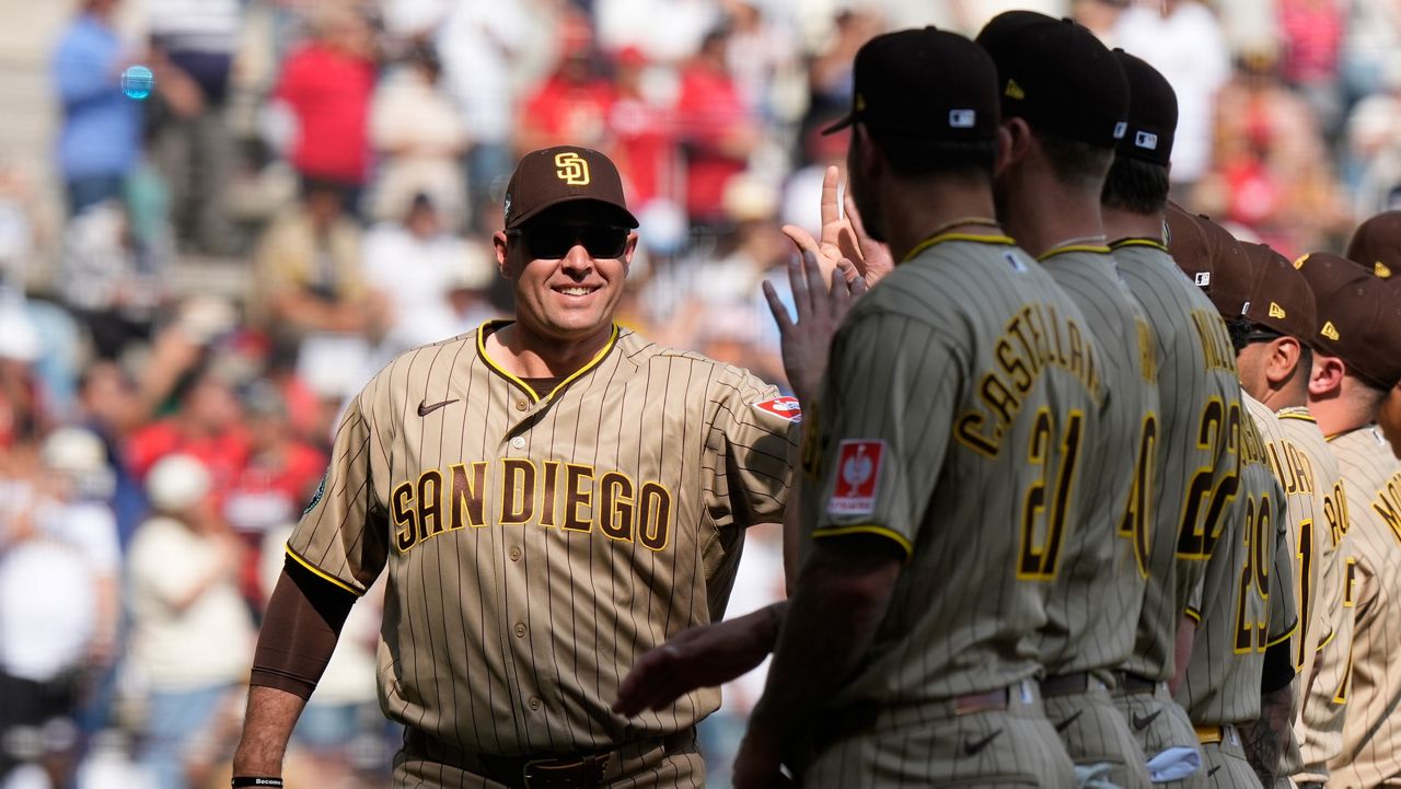 San Diego Padres' manager Craig Stammen, left, enters the field prior to a baseball game against Arizona Diamondbacks in Mexico City, Saturday, April 25, 2026. (AP Photo/Fernando Llano)