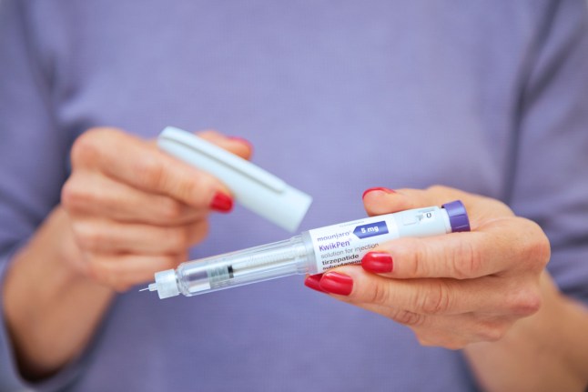 A photo illustration of a woman's hands holding a Mounjaro pen