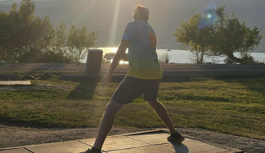 A man plays disc golf.