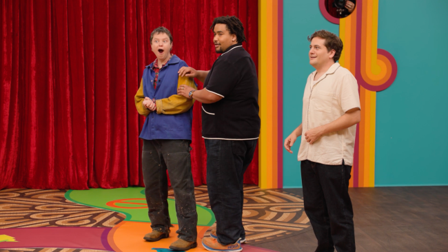 'Game Changer' Season 8 featuring Ally Beardsley, Lou Wilson, and Jeremy Culhane all looking off camera with shocked faces. 