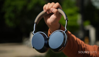 A photo of someone holding the Sennheiser MOMENTUM 5 Wireless headphones at arm's length.