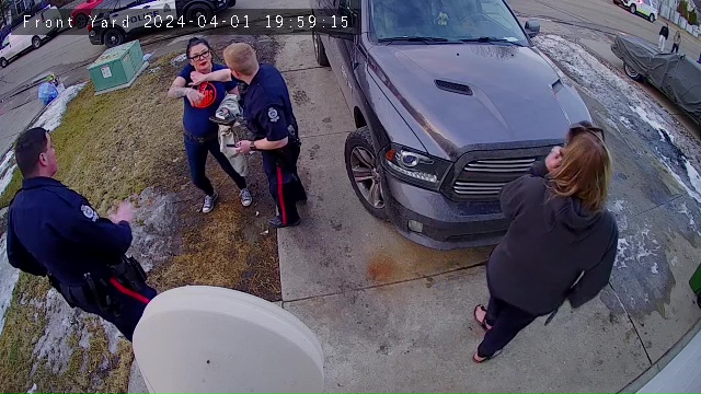 Edmonton police stopping Crystal MacDonald from entering her home in south Edmonton’s Summerside neighbourhood, shortly after Kache Grist was killed by her two dogs in April 2024.