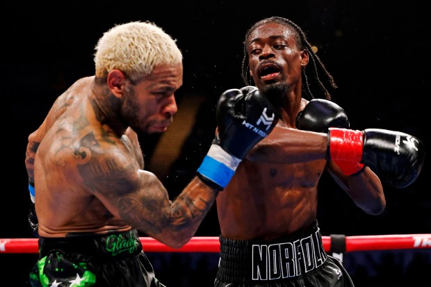 Kelvin Davis lands punch on Peter Dobson during a welterweight boxing match at Scope Arena in Norfolk, Va., on May 16, 2026. (Peter Casey / The Virginian-Pilot)